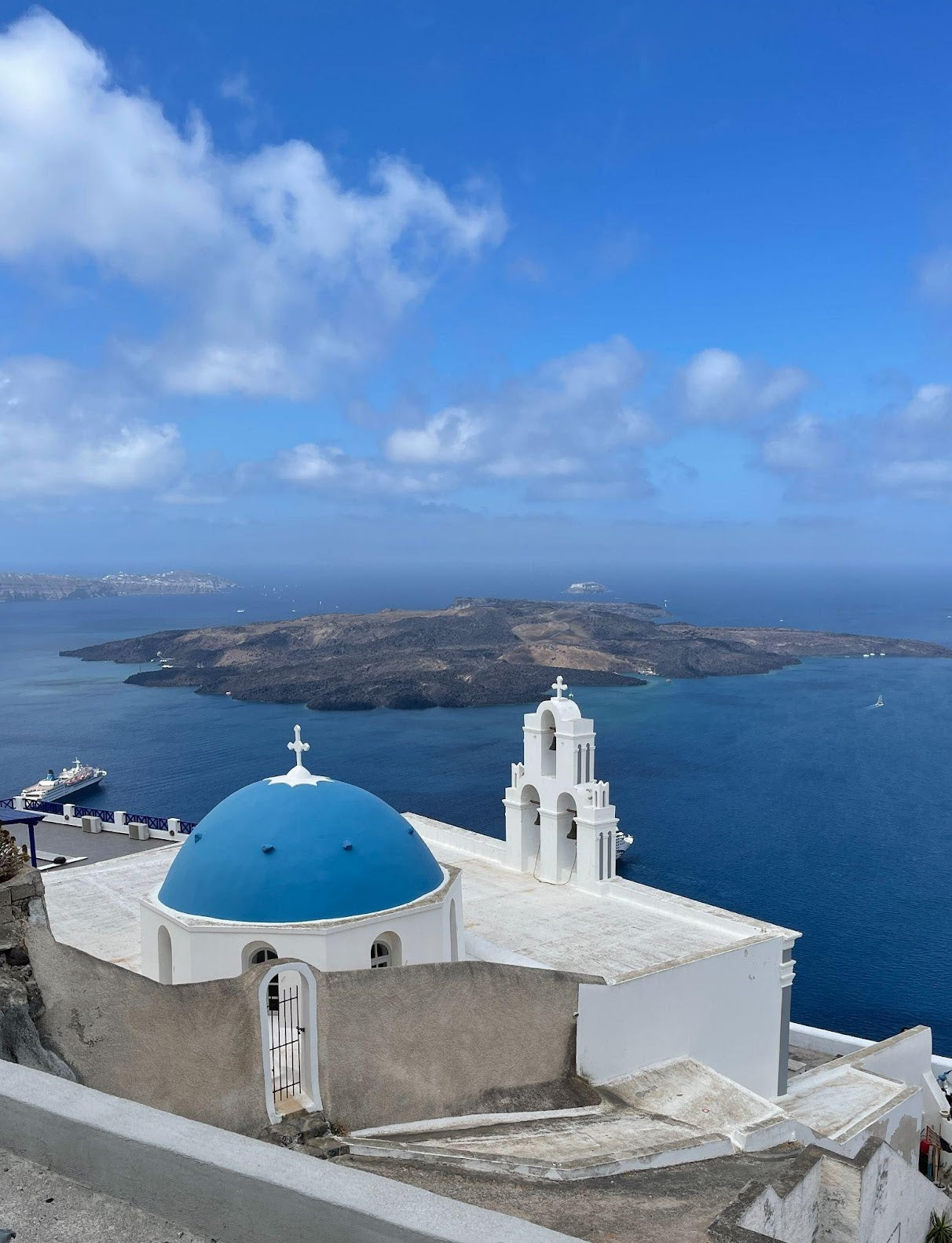 Capture the famous blue domes of Santorini, a postcard-perfect view of Cycladic architecture.