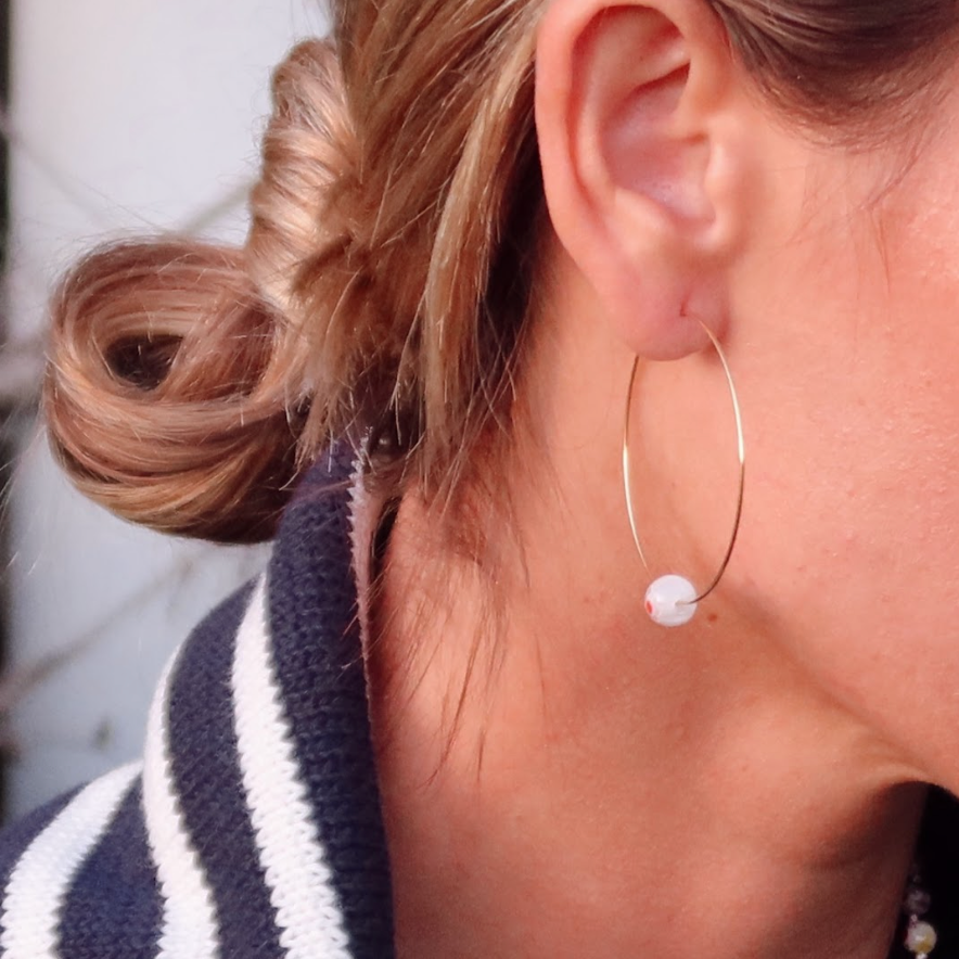 Gold hoop earrings with colorful Millipore beads.