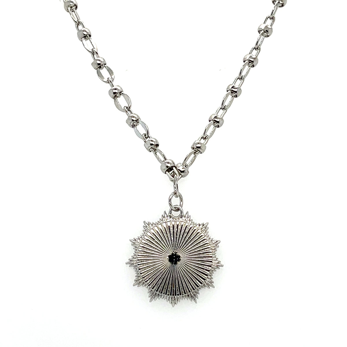 Silver chain necklace with a silver medallion in the shape of an elephant.