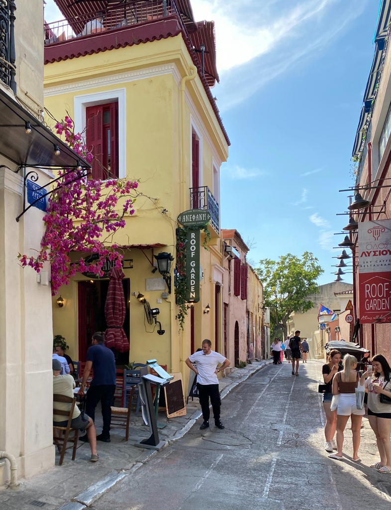 Wander through Greece’s charming corners, filled with whitewashed walls, flowers, and timeless beauty.