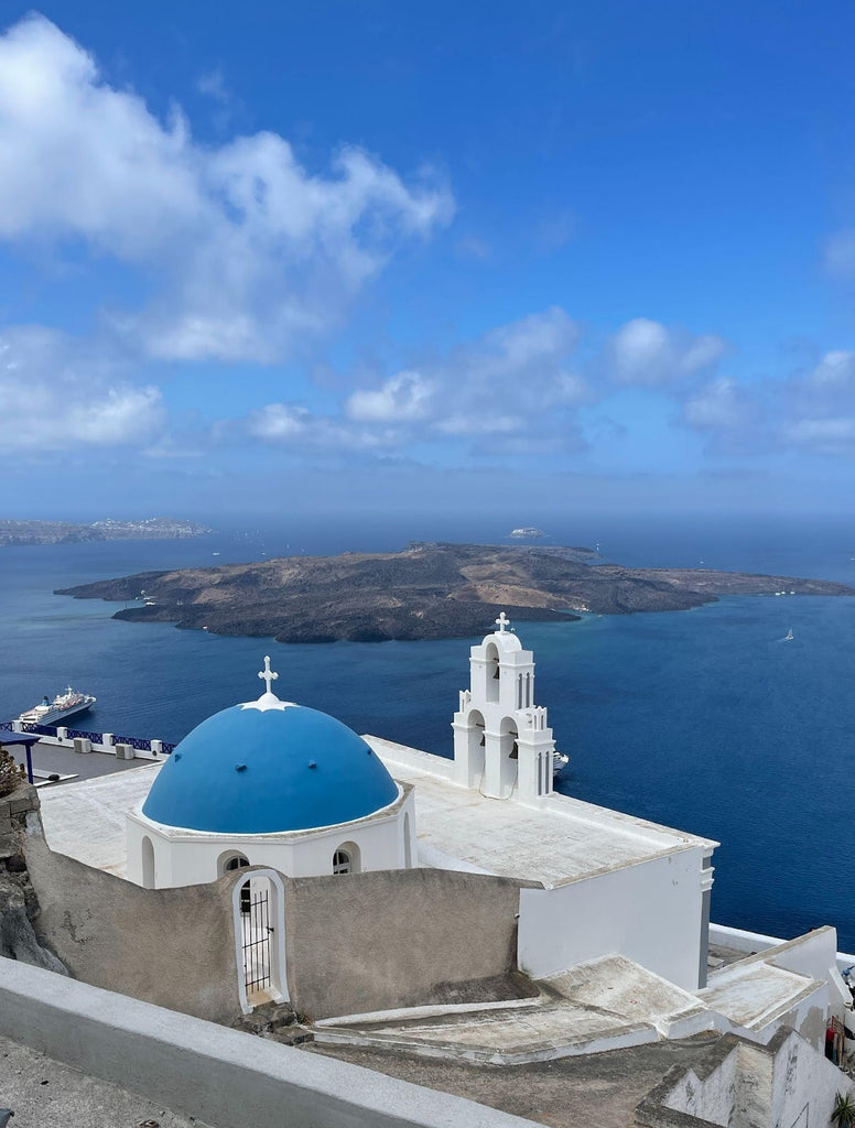 Capture the famous blue domes of Santorini, a postcard-perfect view of Cycladic architecture.