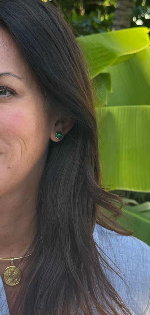 These gold-plated stainless steel stud earrings showcase striking malachite stones, renowned for their rich green hues and captivating natural patterns. Set in a refined bezel frame, the vibrant malachite adds a touch of earthy elegance and bold color to any look.