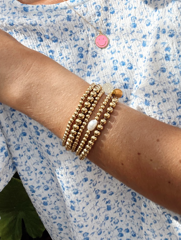 This daughter bracelet is one piece to a set of mother-daughter bracelets. This sentimental gold-filled beaded bracelet is the perfect simple piece to bring a little pop into any stack.