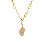 A gold finished link chain necklace with a seashell pendant.