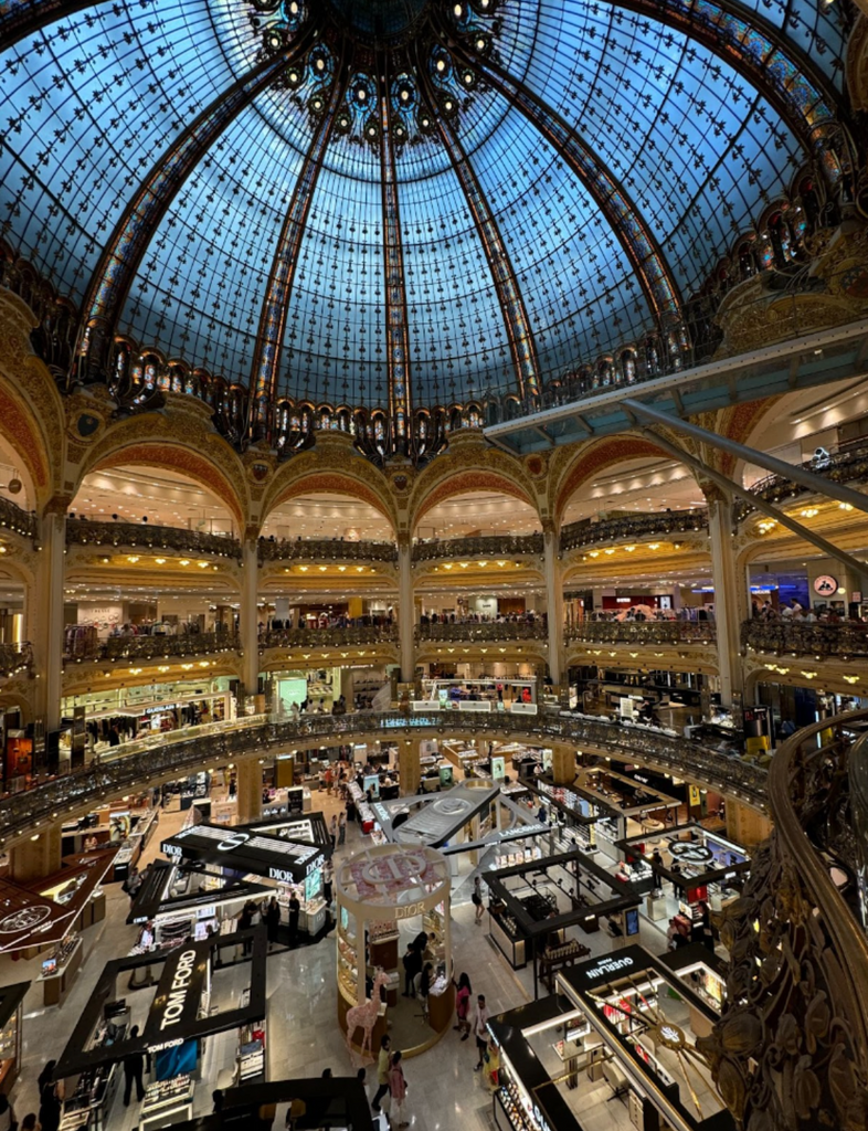 Experience luxury shopping at Galeries Lafayette, Paris’s iconic department store with a glass-domed ceiling.