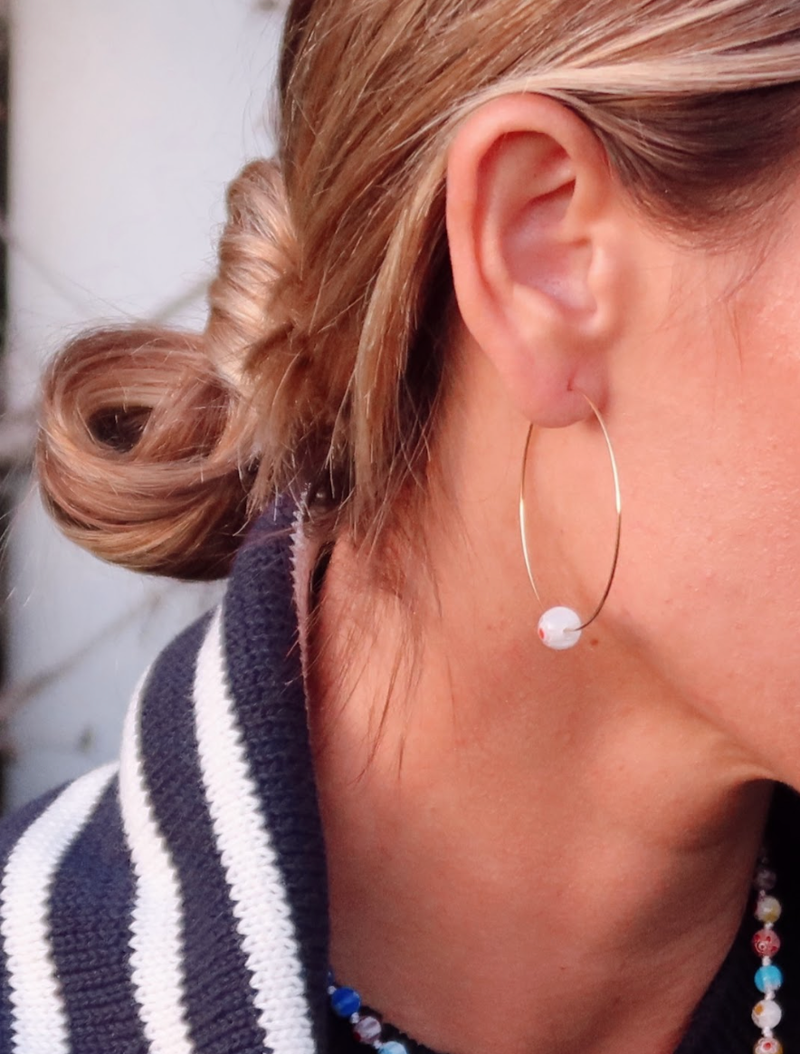 Gold hoop earrings with colorful Millipore beads.