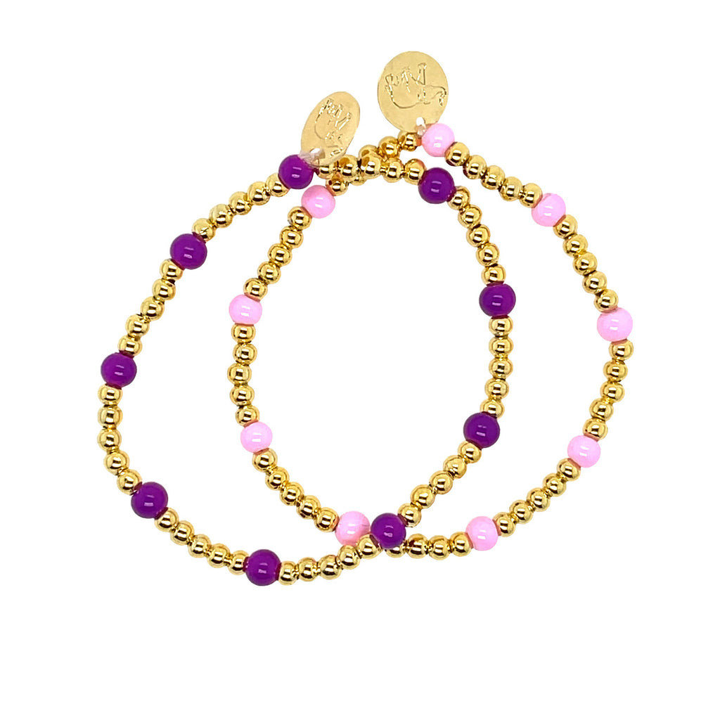 Stack of gold ball bead bracelet with purple and pink beads