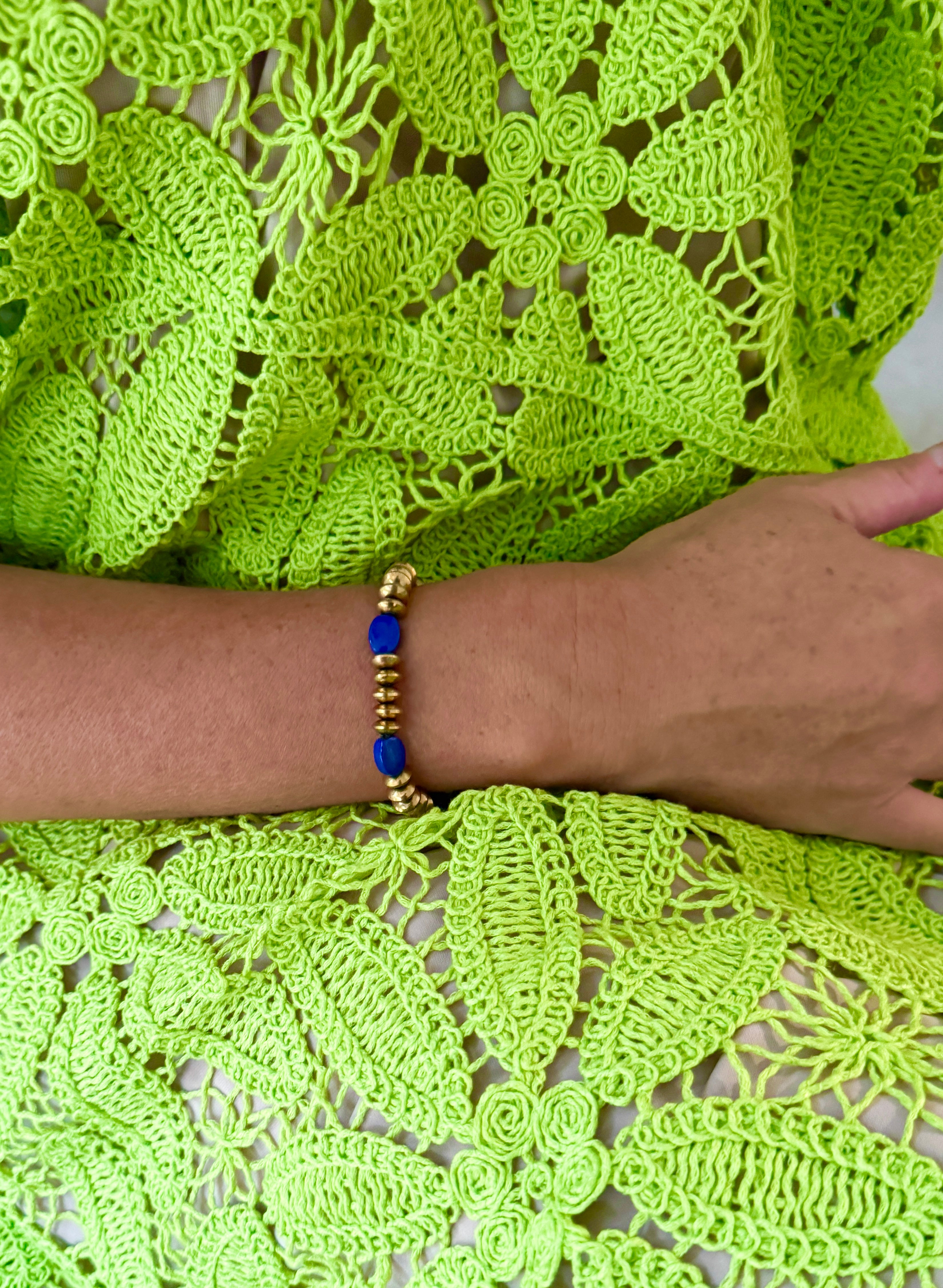This stunning bracelet features a harmonious blend of gleaming gold beads and vibrant blue stones, creating a striking accessory that adds a touch of elegance and color to any ensemble.