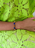 This stunning bracelet features a harmonious blend of gleaming gold beads and vibrant blue stones, creating a striking accessory that adds a touch of elegance and color to any ensemble.