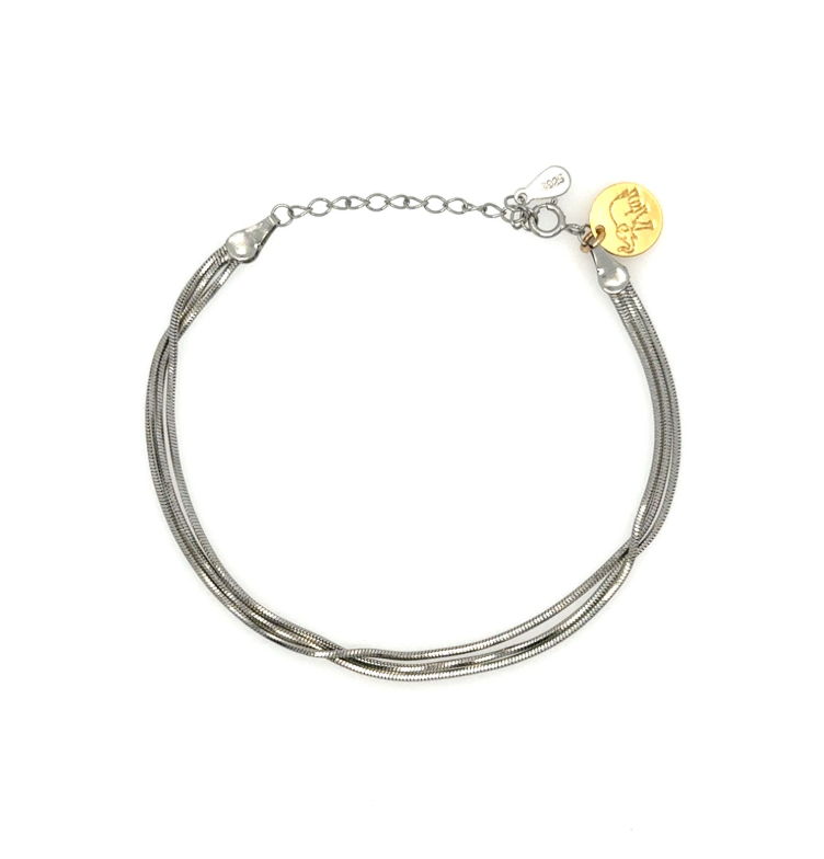 A silver-toned multi-strand snake chain bracelet with a small gold disc charm engraved with an elephant, displayed on a clean white background.