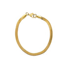 A gold-colored snake chain bracelet isolated on a white background