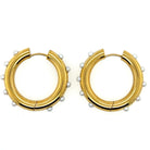Gold plated stainless steel hoop earrings, 1 inch x 1 inch, accented with elegant white pearls.
Timeless and tarnish-resistant—perfect for daily wear, formal events, or bridal accessories.