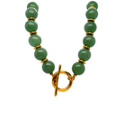 Green beaded bracelet with a gold clasp on a white background