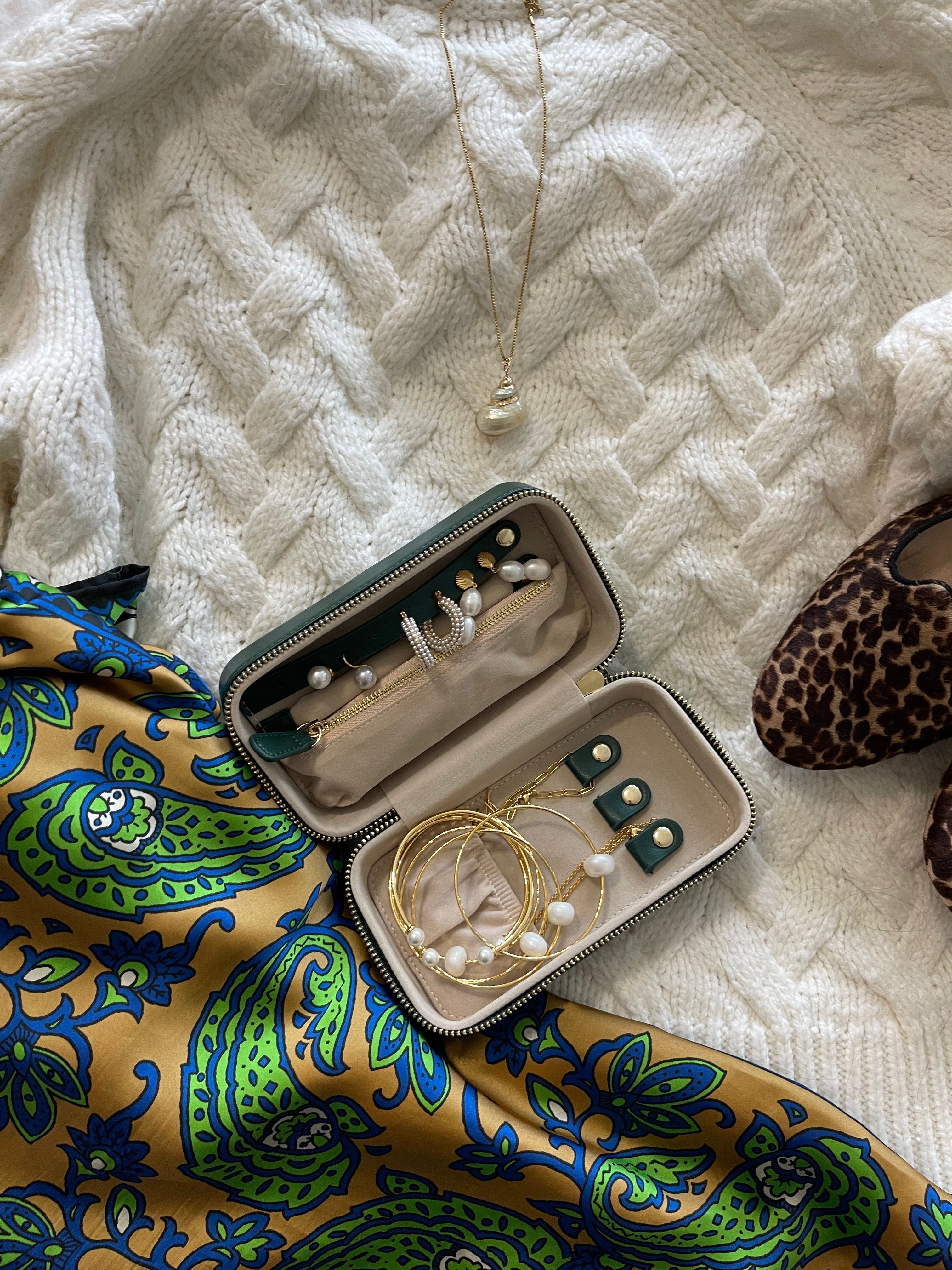 Compact leather jewelry organizer for travel, 6.75" x 3.5" x 2.5" with divided compartments and soft lining.
Stylish and protective—ideal for vacations, weekend trips, or everyday storage.
