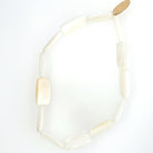 Stylish 2.75-inch diameter bracelet with 0.5-inch flat pearl tiles, offering a sleek, modern touch.
