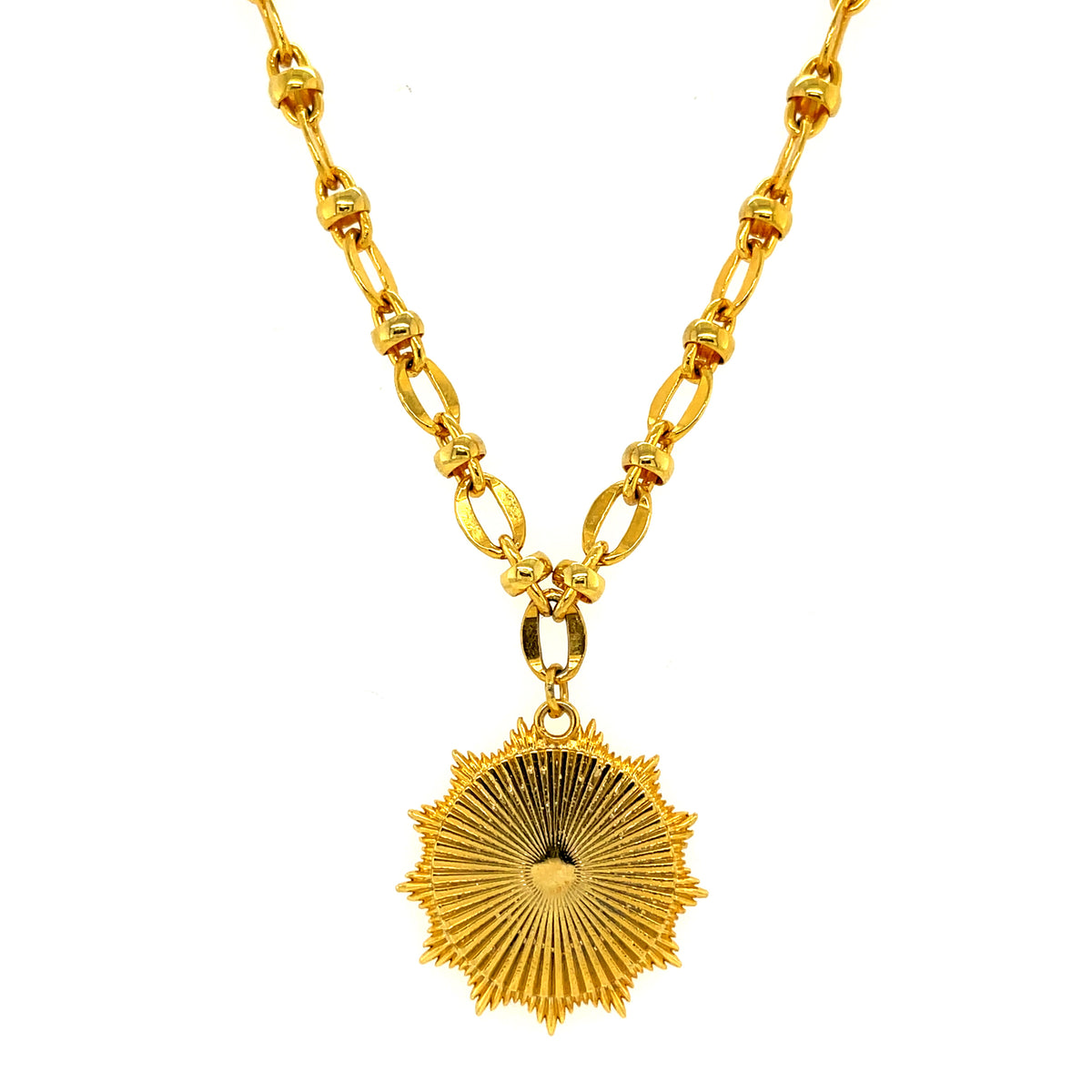 A gold-plated necklace with a textured medallion pendant on a chain link.