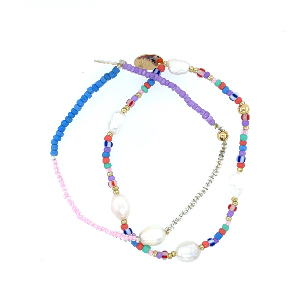 Stack of 2 multi bead and pearl bracelets with 2.5-inch diameter featuring 0.5-inch lustrous pearl beads.
Elegant layered design perfect for boho chic, gifting, or adding sophistication to any outfit.